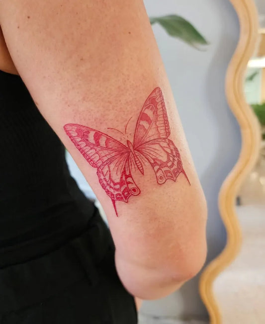 Medium Red Butterfly Tattoo on Women Arm by @daniel.nabil_ink