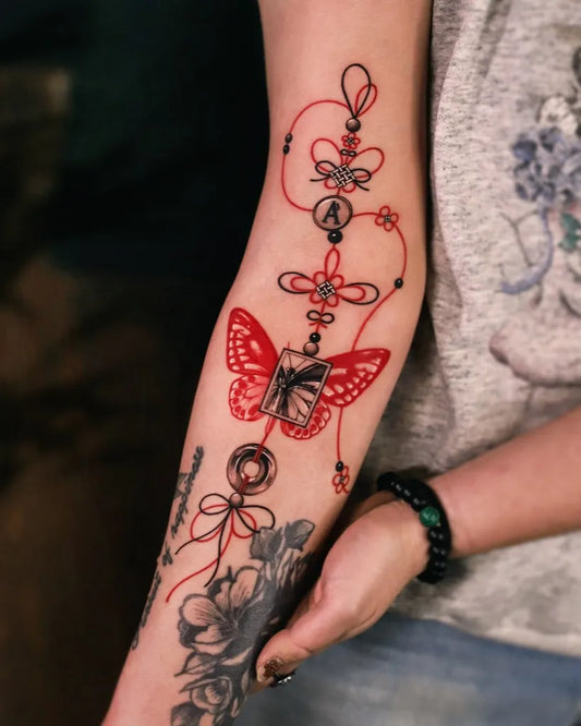 Medium Red Butterfly and Red String Tattoo on Women Arm by @zeeyeart