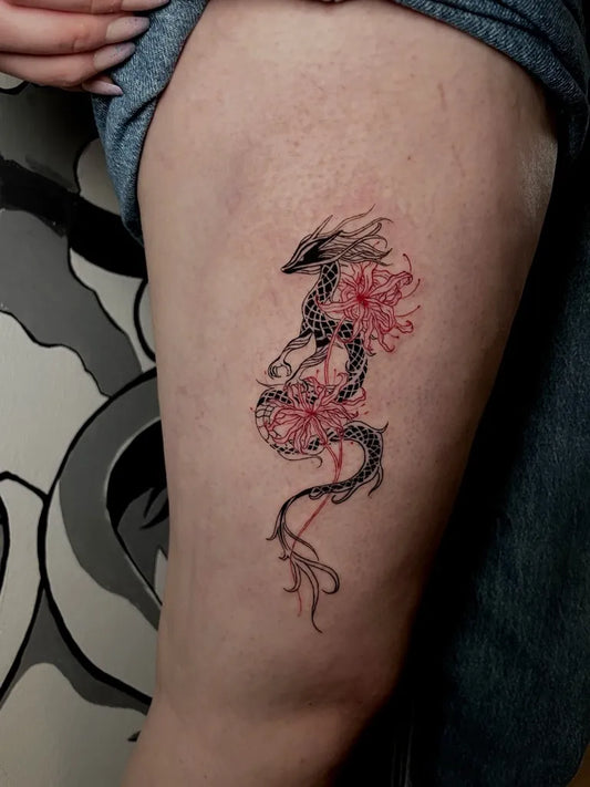 Medium Red Dragon with Flowers Tattoo on Women Thigh by @tattooist.jules