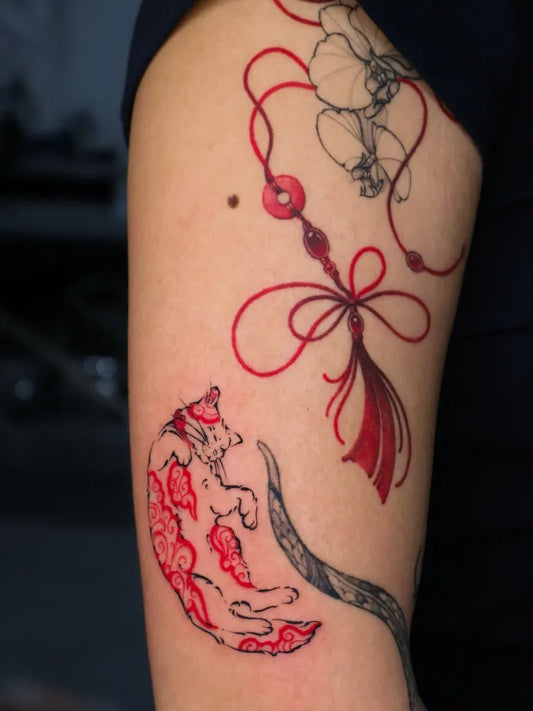 Medium Red RedStringCatTattoo on Women Arm by @zarmina_tattoo
