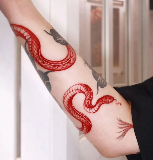 Medium Red Snake Tattoo on Women Arm by @rahon_tatt