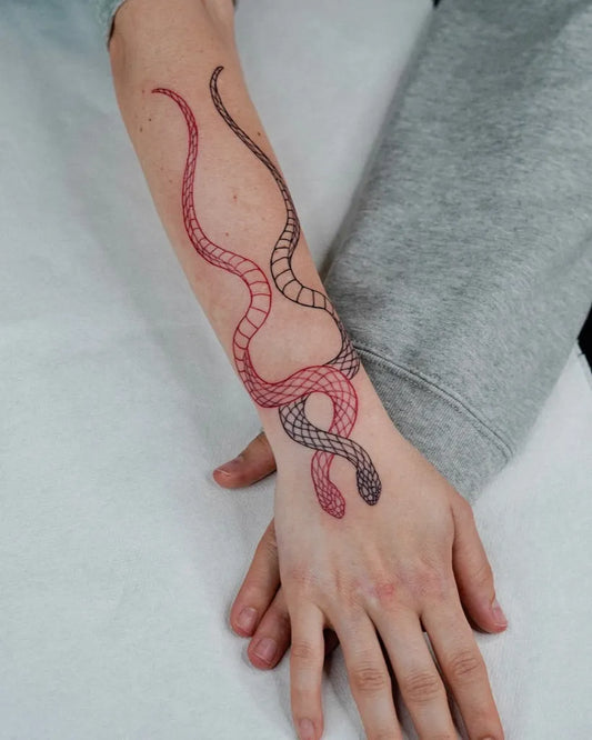 Medium Red Twin Snakes Tattoo on Women Forearm by @miseria.ttt
