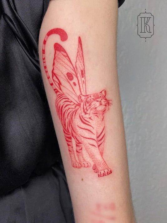 Medium Red Winged Tiger Tattoo on Women Arm by @ksena.tattoo