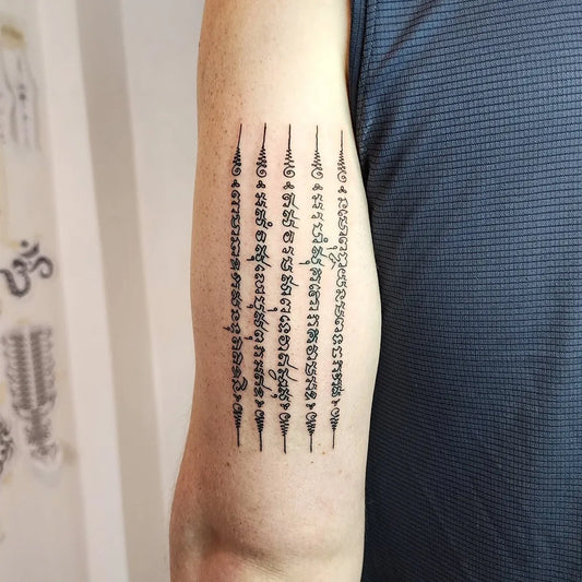Medium Sak Yant Sak Yant Script Tattoo on Men Arm by @nomoreinktattoo