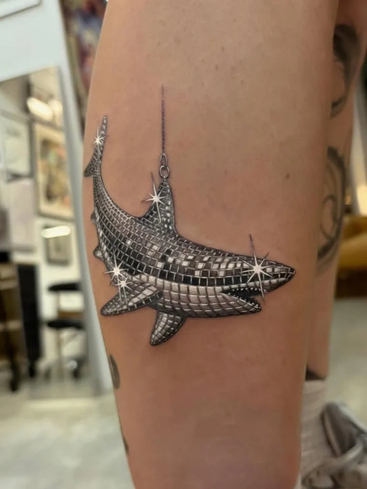 Medium Silver Mirrorball Great White Shark with Sparkles on Women Thigh Tattoo by @theartoftattooingofficial