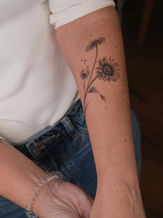 Medium Stick and Poke Dandelion Sunflower Stem Tattoo on Women Arm by @maria_pokes