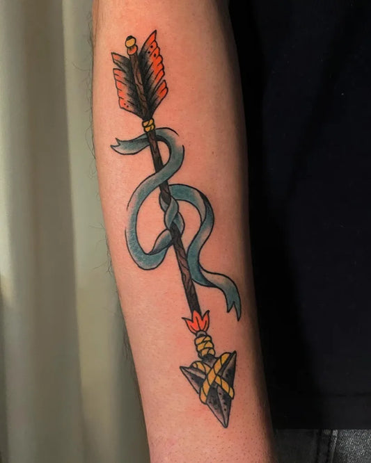 Medium Traditional Arrow with Ribbon Tattoo on Men Arm by @fotini_tattoo