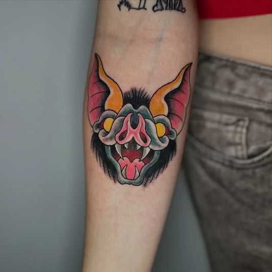 Medium Traditional Bat Tattoo on Women Arm by @spice_tats