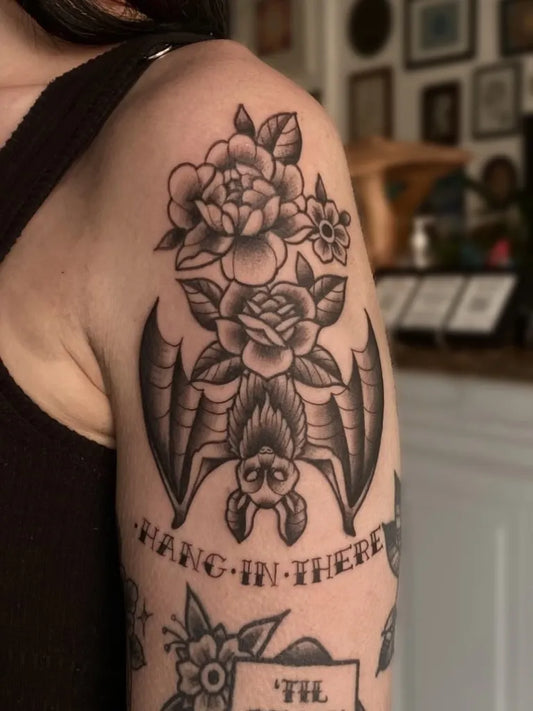 Medium Traditional Bat and Roses Tattoo on Women Shoulder by @courtney.tattoos