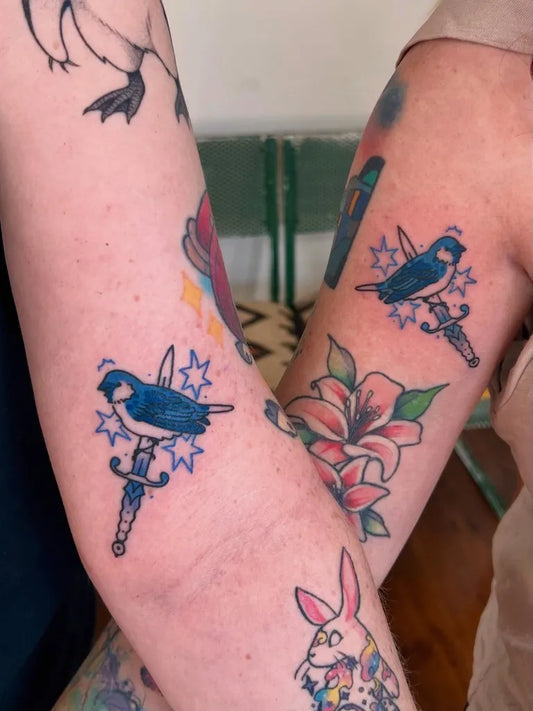 Medium Traditional Bluebird Knife Tattoo on Women Arm by @taurusteej.tattoos