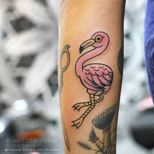 Medium Traditional Flamingo Broom Tattoo on Women Arm by @tos_tattoo