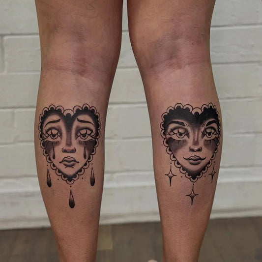 Medium Traditional Heart Faces on Women Legs Tattoo by @tradbones