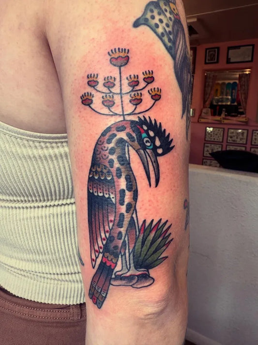 Medium Traditional Hornbill with Floral Motif Tattoo on Women Arm by @baileyhrobinson