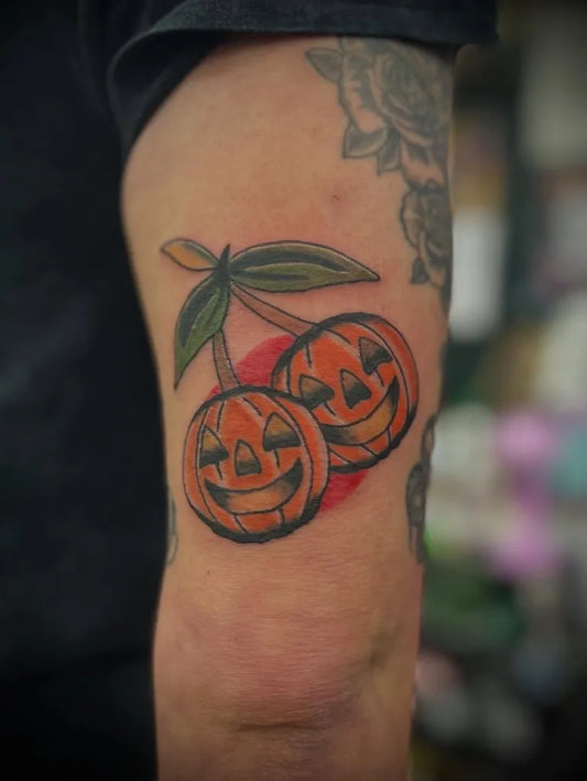 Medium Traditional Jack o lantern Cherries Two Halloween Tattoo on Men Arm by @tattoos.by.heff