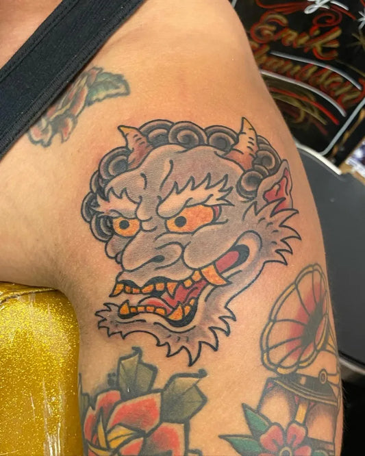 Medium Traditional Oni Mask with Flowers on Women Shoulder Tattoo by @evjtattoos