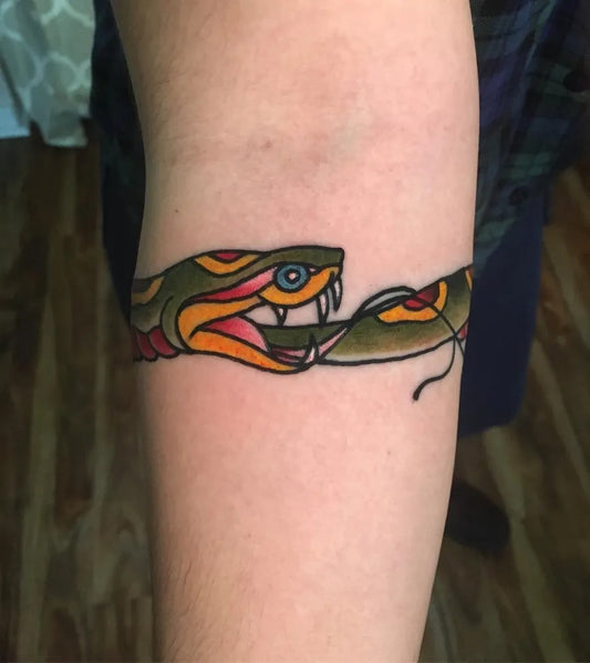 Medium Traditional Ouroboros Tattoo on Women Arm by @cody_tattoos