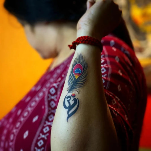 Medium Traditional Peacock Om Tattoo on Women Wrist by @walldogstattoogurugram
