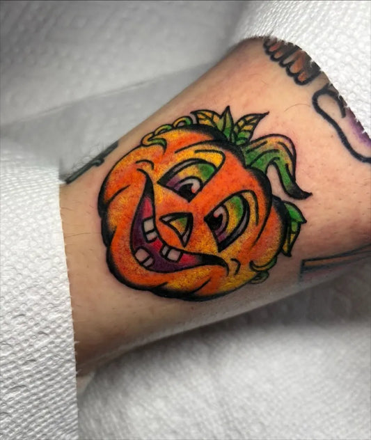 Medium Traditional Pumpkin Halloween Tattoo on Women Arm by @kenxie.art