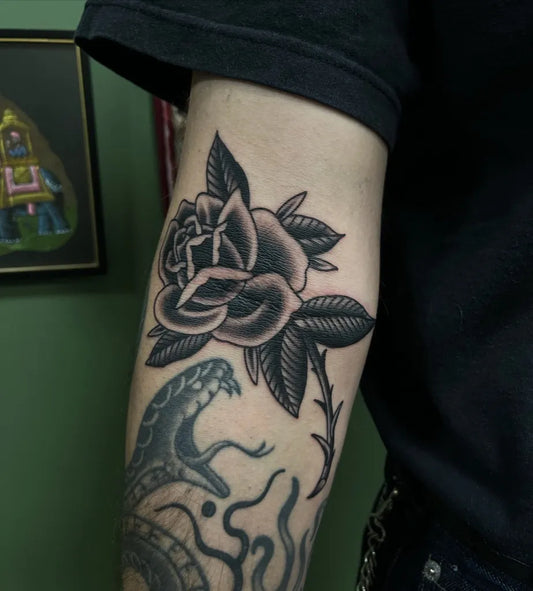 Medium Traditional Rose Snake Tattoo on Men Arm by @matas.ta