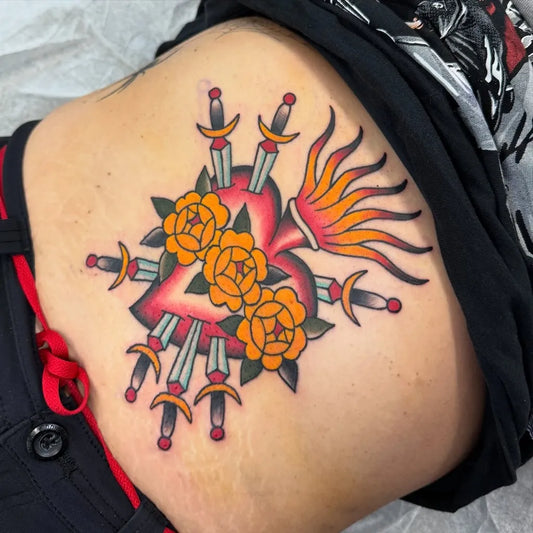Medium Traditional Sacred Heart with Daggers and Roses Tattoo on Women Hip by @sunflowertattoochi
