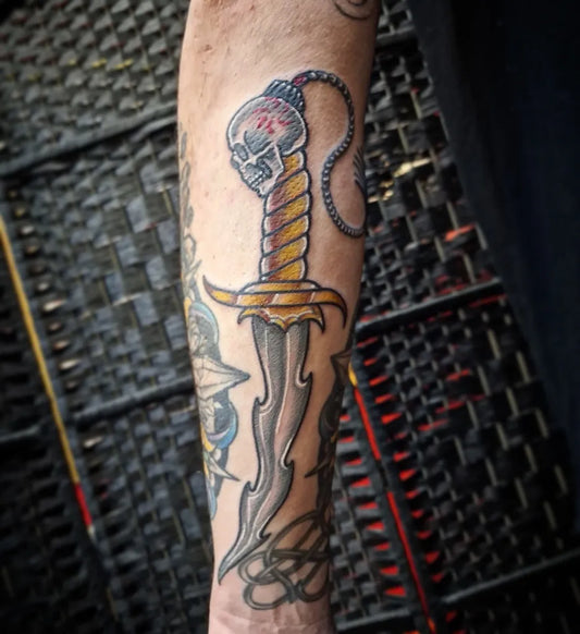 Medium Traditional Skull Dagger Tattoo on Men Arm by @bloodofangelscambridge