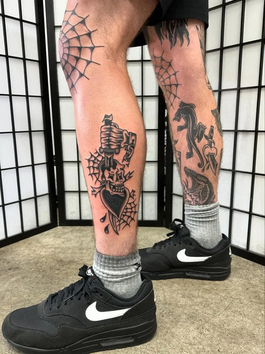 Medium Traditional Spiderweb Heart Gun Tattoo on Men Thigh by @jackxtattoo