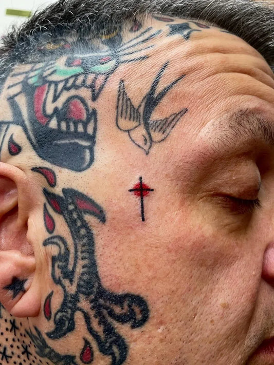Medium Traditional Tiger Swallow Cross Tattoo on Men Face by @charlescoopertattooing