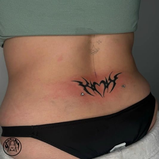 Medium Tribal Heart Tattoo on Women Lower Back by @shalombodyart