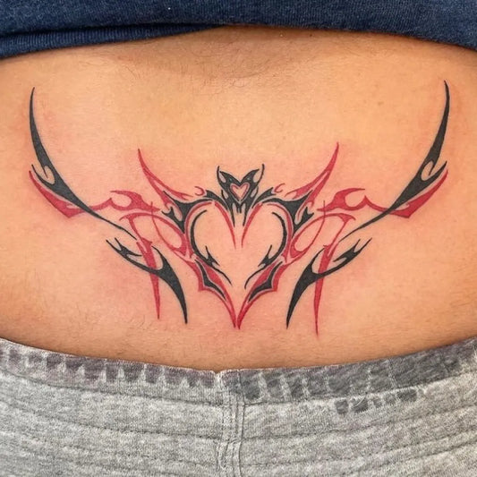 Medium Tribal Heart Wings Tattoo on Women Lower Back by @livebytheswordtattoo