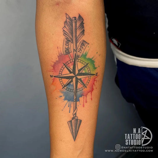 Medium Watercolor Arrow Compass Tattoo on Men Arm by @tattoosbysujeet