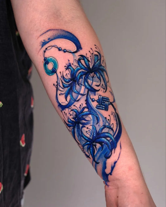 Medium Watercolor Blue Spider Lily and Beads Tattoo on Women Arm by @melange.tattoo