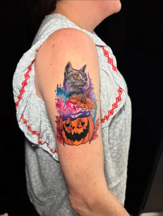 Medium Watercolor Cat and Pumpkin Halloween Tattoo on Women Arm by @riotinkohio