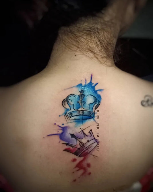 Medium Watercolor Crown with Splatter Tattoo on Women Back by @triple_k_ink_tattoo