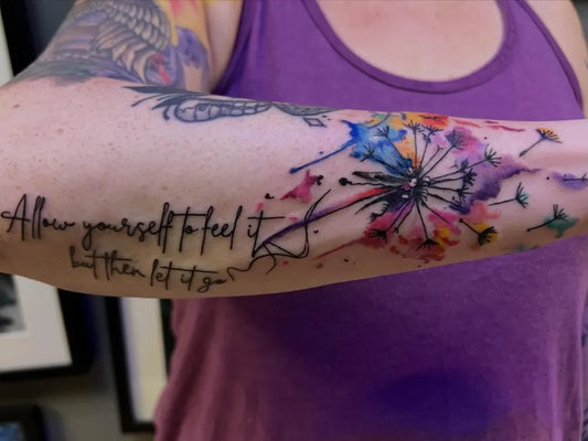 Medium Watercolor Dandelion and Quote Tattoo on Women Arm by @lyonsdentattoocompany