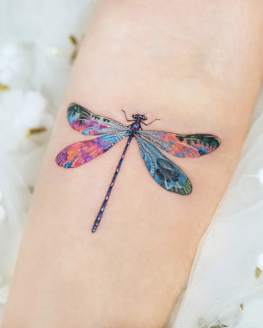 Medium Watercolor Dragonfly on Women Arm Tattoo by @enni.tattoo