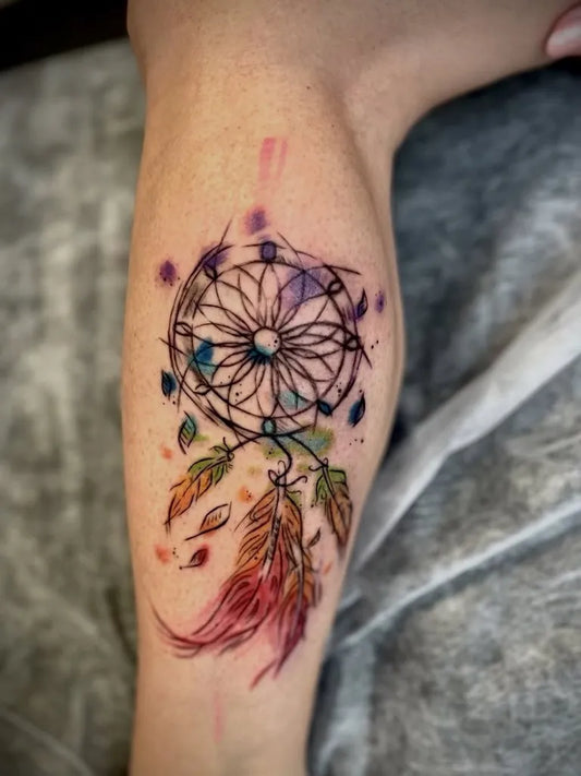 Medium Watercolor Dream Catcher Feathers Tattoo on Women Leg by @terrywolf_ink