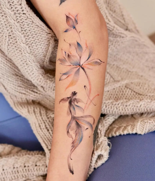 Medium Watercolor Fish and Lotus Tattoo on Women Arm by @lilyl_blankleaving