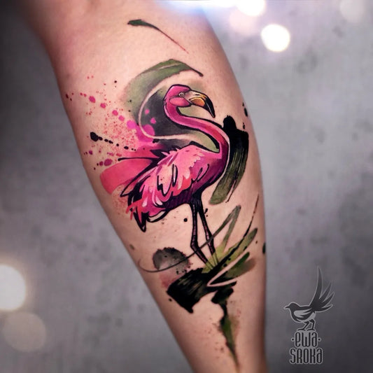 Medium Watercolor Flamingo and Leaves Tattoo on Women Leg by @ewasrokatattoo