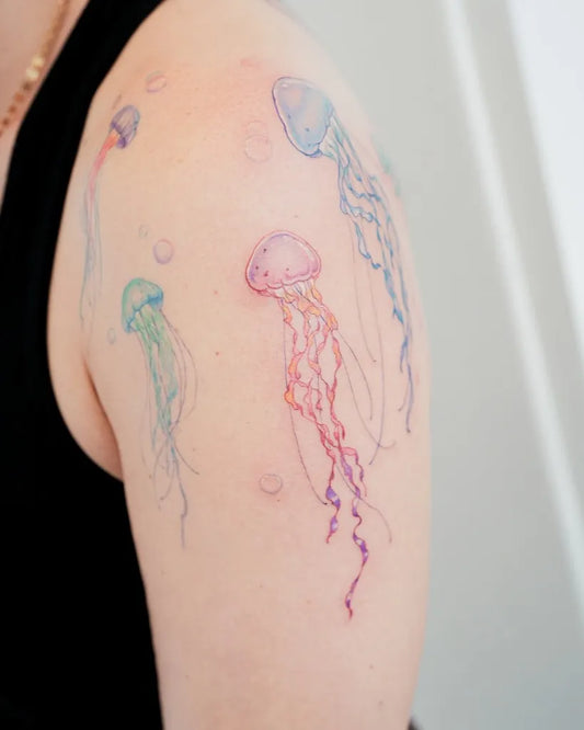 Medium Watercolor Jellyfish and Bubbles Tattoo on Women Arm by @avis.tattooer