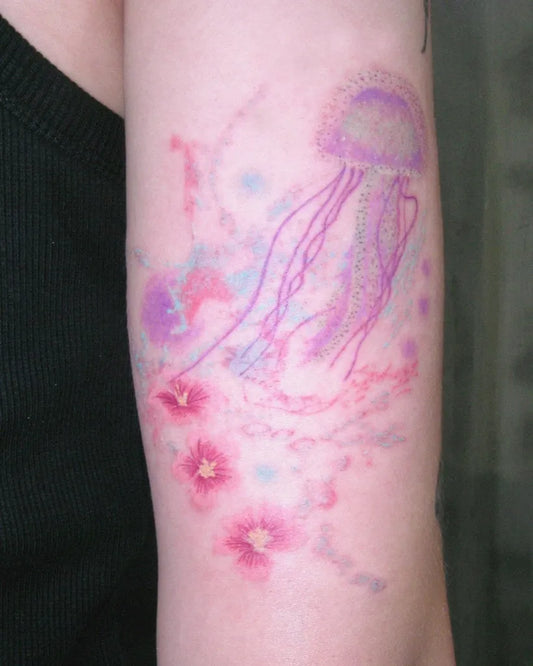 Medium Watercolor Jellyfish and Flowers Tattoo on Women Arm by @pinselgarden