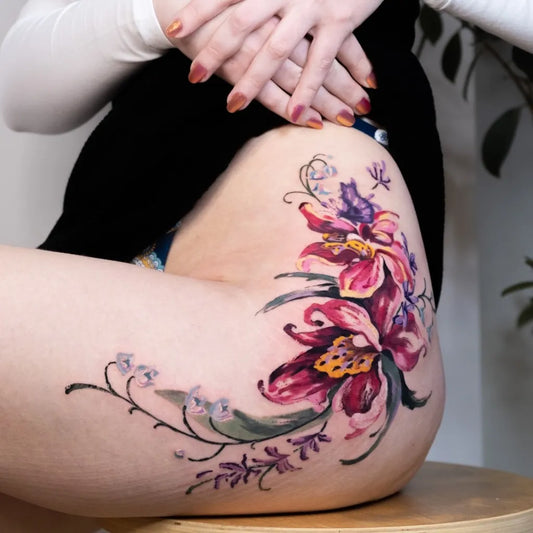 Medium Watercolor Lily of the Valley and Floral Cluster on Women Hip Tattoo by @oneultattoo