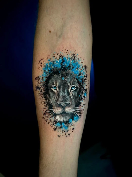 Medium Watercolor Lion with Blue Splash on Women Arm Tattoo by @warsztat.tattoo