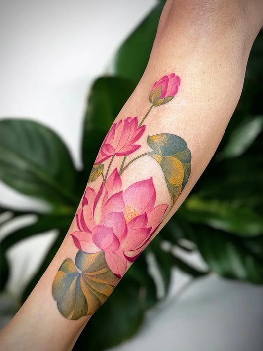 Medium Watercolor Lotus Flower Leaves on Women Arm Tattoo by @in_kalaya_tattoos