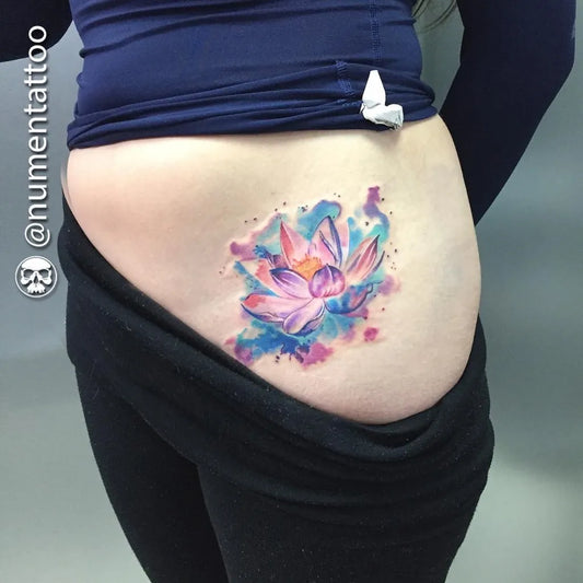 Medium Watercolor Lotus Flower on Women Hip Tattoo by @numentattoo