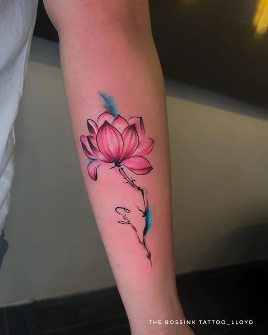 Medium Watercolor Lotus Flower with Name on Women Arm Tattoo by @thebossink.tattoo
