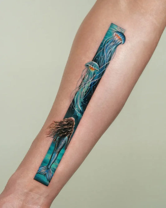 Medium Watercolor Mermaid and Jellyfish Tattoo on Women Arm by @enni.tattoo