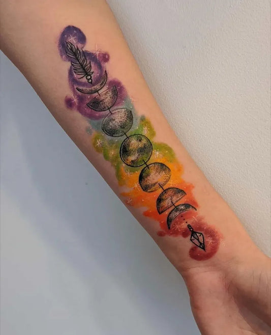 Medium Watercolor Moon Phases Feather Tattoo on Women Arm by @ascensiontattoonc