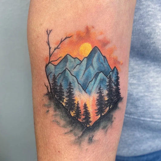Medium Watercolor Mountain Forest Sun Tattoo on Women Arm by @macofer.tattoos