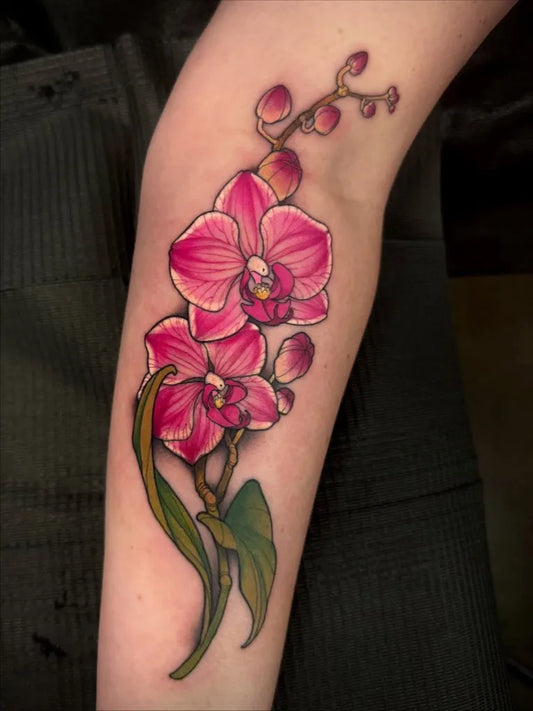 Medium Watercolor Orchid Flowers Tattoo on Women Arm by @emjey.tattoos