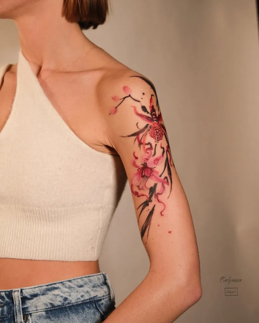 Medium Watercolor Orchid Flowers Tattoo on Women Shoulder by @belyaeva.tattoo